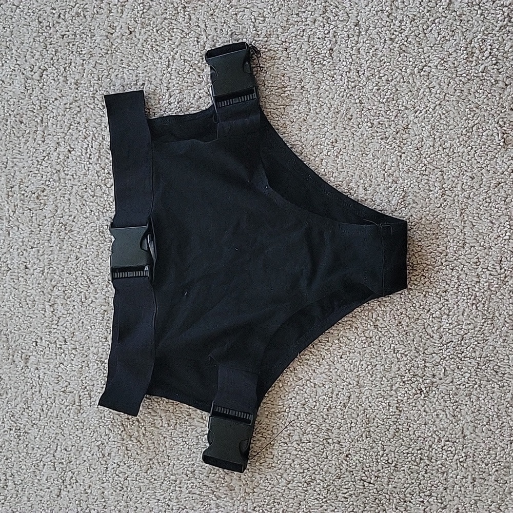High cut bottom, side cut-out, buckles